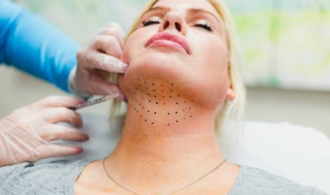 Blonde lady getting her double-chin removed without surgery