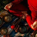 person in red long sleeve shirt holding brown wooden handle